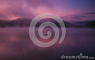 Fog at dawn over Lake Solina in the Bieszczady Stock Photo