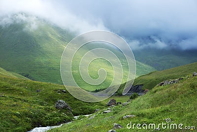 Fog descends into the valley. Stock Photo