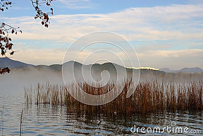 Fog growing on quiet lake waters landscape in Banyoles, Catalonia Stock Photo
