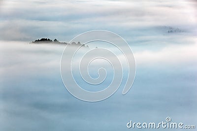 Fog with island hill, misty morning. Hills and villages with foggy morning. Morning fall valley of Bohemian Switzerland park. Stock Photo