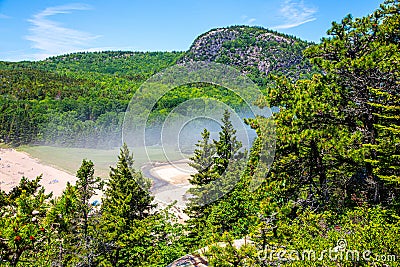 Fog over Sand Beach with Beehive Trail Cliffs in the background, Acadia National Park, Maine Stock Photo