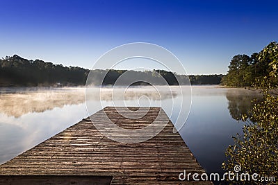 Fog settles on Lake Dow during sunrise in McDonough, GA. Stock Photo