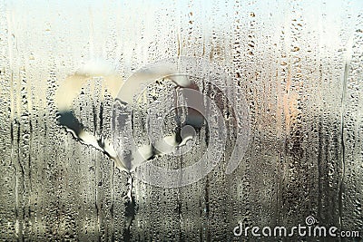 Fogged up glass with painted heart with many drops Stock Photo