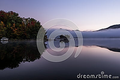 Foggy Lake and Green Mountains - Island with Colorful Trees - Autumn / Fall - Vermont Stock Photo