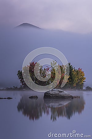 Foggy Lake and Green Mountains - Island with Colorful Trees - Autumn / Fall - Vermont Stock Photo