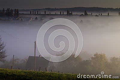 Foggy landscape and house with red roof Stock Photo