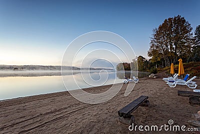 Foggy morning in lake of Algonquin Provincial Park, Ontario, Canada with benches Stock Photo