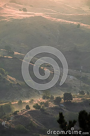 Foggy scenery over the hills with an epic light from the sunrise. Stock Photo