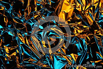 Foil background. Crumpled foil. Abstract background. Wallpaper. Yellow and blue Stock Photo