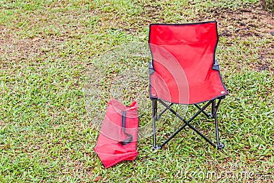 Foldable camping chair with the green lawn background. Stock Photo