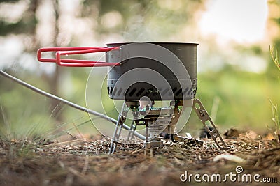 Foldable camping gas fire system with a pot with radiator for fast heating Stock Photo