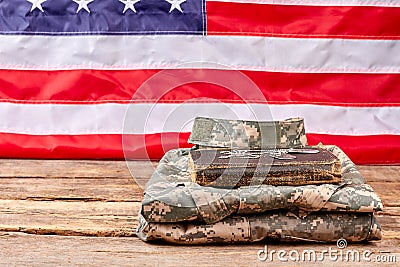 Folded army uniform with book and dog tags. Stock Photo