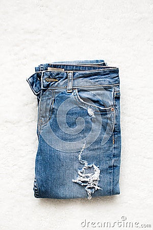 Folded blue jeans lie on a white background Stock Photo