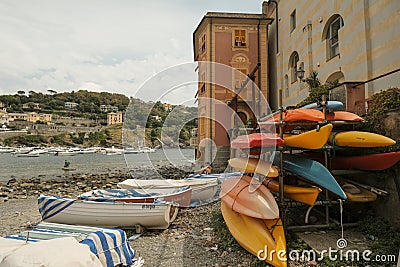 Folded boats in the bay of the Silence in Sestri Levante, Liguria, Italy across the colorful houses, mountains, and coastline Editorial Stock Photo