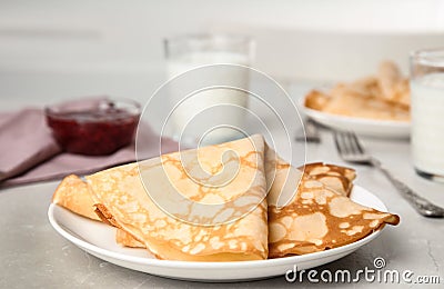 Folded fresh thin pancakes on grey table Stock Photo