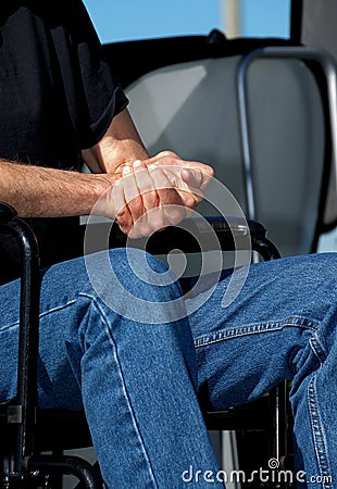 Folded Hands in a Wheelchair Stock Photo