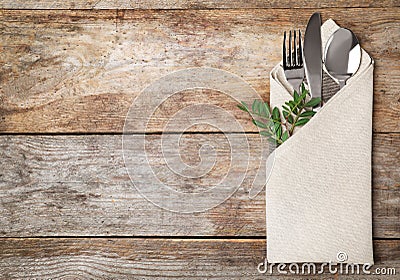 Folded napkin with fork, spoon and knife Stock Photo