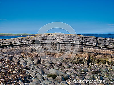 The folded rock strata of Greymare Rock on the Northumberland coast, near Dunstanburgh Castle. Stock Photo