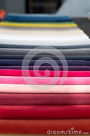 Folded soft luxury velvet samples placed in a row on a table Stock Photo