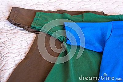 Folded t-shirts different colours. T-shirt sleeves close up Stock Photo