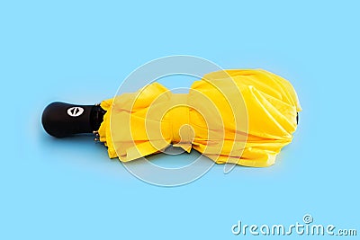 Folded umbrella on blue background Stock Photo