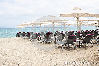 Folded umbrellas on the beach before the storm on the coast of G Stock Photo