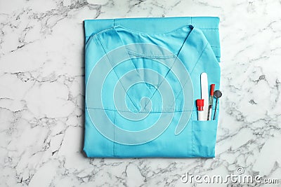 Folded uniform with medical objects in pocket Stock Photo