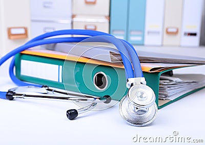 Folder file, stethoscope and RX prescription on the desk. blurred background. Stock Photo