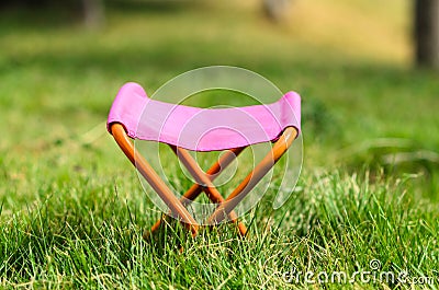 Folding camping stool in the park outdoor Stock Photo
