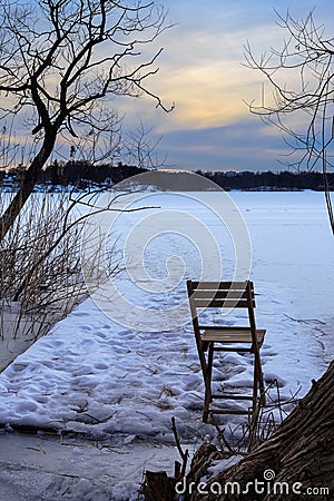 Folding chair on frozen lake Stock Photo