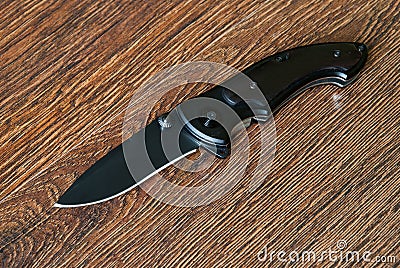 Folding knife with wooden handle. EDC knife Stock Photo