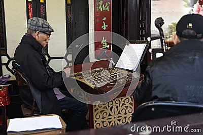 Folk artist who is playing Chinese national musical instruments Editorial Stock Photo