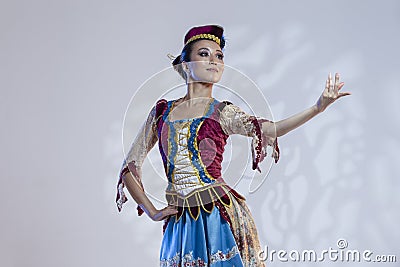 Folk Ballet Ideas. Young Japanese Female Ballet Dancer In Stage Outfit Costume Posing in Dance Pose On White Background With Stock Photo