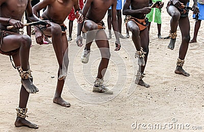 Folk dance on the sand. Feet of dancing Africans on a sandy surface Stock Photo