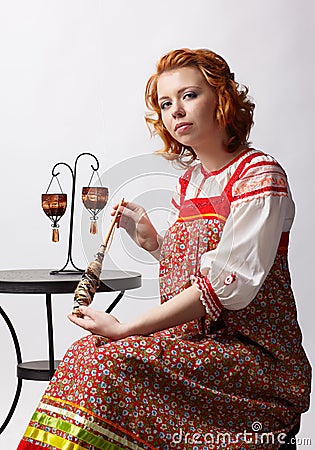 Folk girl with distaff Stock Photo