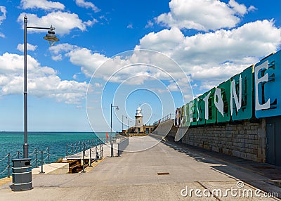 Folkestone Harbour, Lighthouse and Sign in the summer Editorial Stock Photo