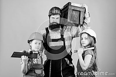 Follow father. Father builder kids girls. Teach daughter. Informal education. Fathers day. Sisters help father builder Stock Photo