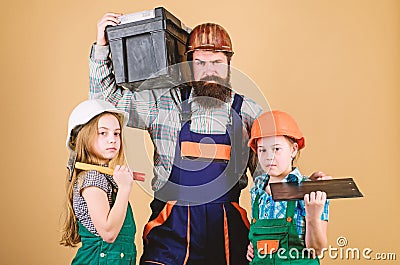 Follow father. Father builder kids girls. Teach daughter. Informal education. Fathers day. Sisters help father builder Stock Photo