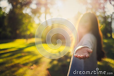 Follow me, a beautiful asian woman holding hands and leads into the park Stock Photo