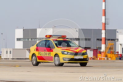 Follow me car moves by airport apron Editorial Stock Photo