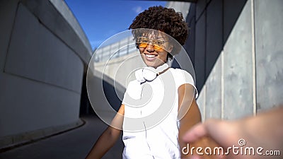 Follow me couple, beautiful afro-american woman looking at camera, travelling Stock Photo