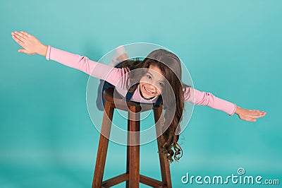 Follow me. Girl kid cheerful imitate plane flying. Kid play game fly as plane with wide apart hands. Child enjoy Stock Photo