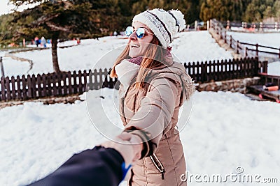 follow me. happy woman and man holding hands. pov. winter season at the mountain. Love concept Stock Photo