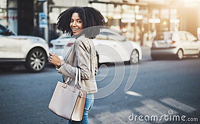 Follow me and Ill show you where my ambitions lie. Portrait of a young businesswoman walking in the city. Stock Photo