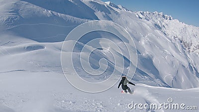 FOLLOW: Snowboarder girl rides off piste towards the slopes of a ski resort. Stock Photo