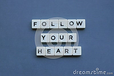 ' Follow Your Heart ' word made of square letter word on grey background Stock Photo
