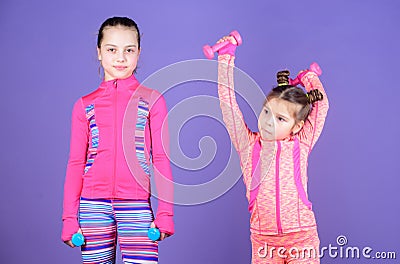 Following her sister. Girls cute kid exercising with dumbbells. Motivation and sport example concept. Toddler repeat Stock Photo