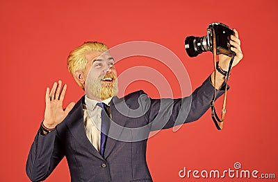 Following his personal style. mature man dyed beard and hair. professional photographer make selfie photo. capture Stock Photo
