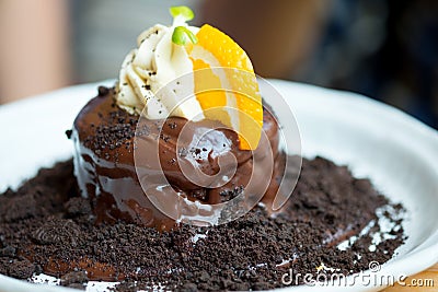 Fondant chocolate cake with orange slice and whip cream Stock Photo