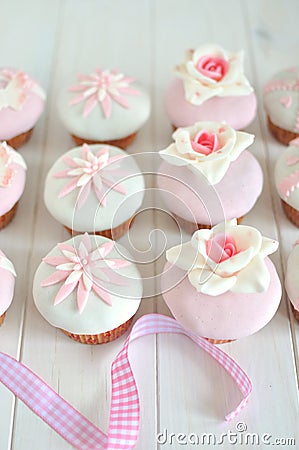 Fondant cupcakes on wooden table Stock Photo